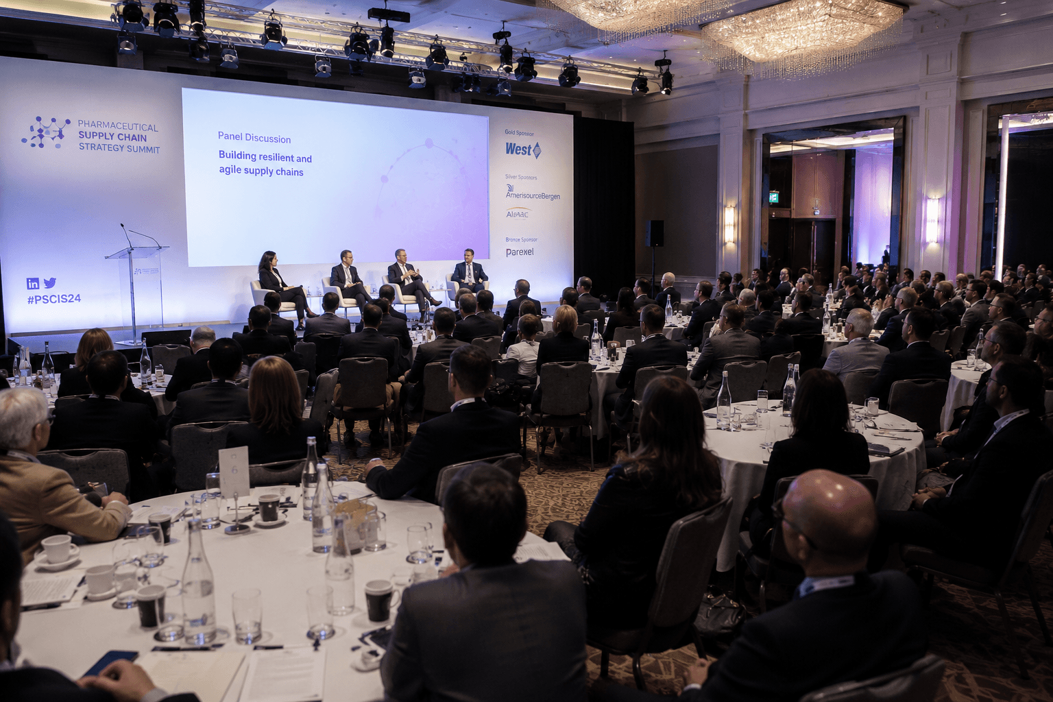 Supply chain summit panel in a ballroom venue